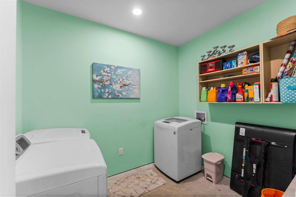 Functional laundry room with shelving for organized storage of laundry essentials.
