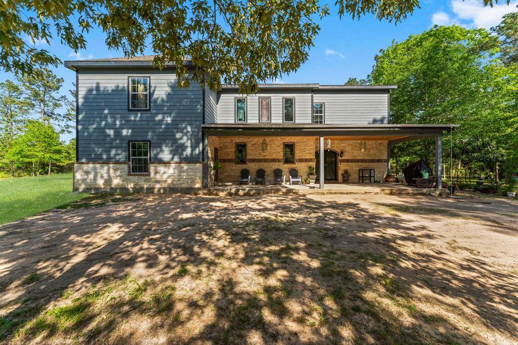 Enjoy the natural beauty surrounding this home, with its generous front yard bordered by mature trees. The substantial covered porch provides a perfect spot to appreciate the outdoors and offers ample space for welcoming guests or simply unwinding.
