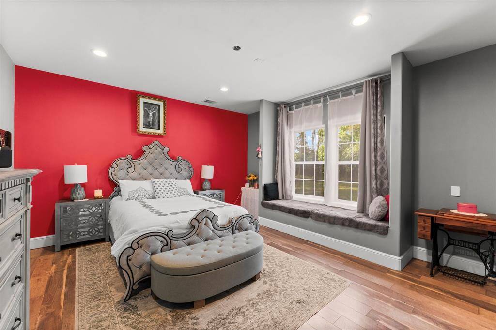 "Retreat to this comfortable bedroom featuring a charming window seat, perfect for reading and relaxation. The stylish design elements and ample natural light create a serene and inviting atmosphere.