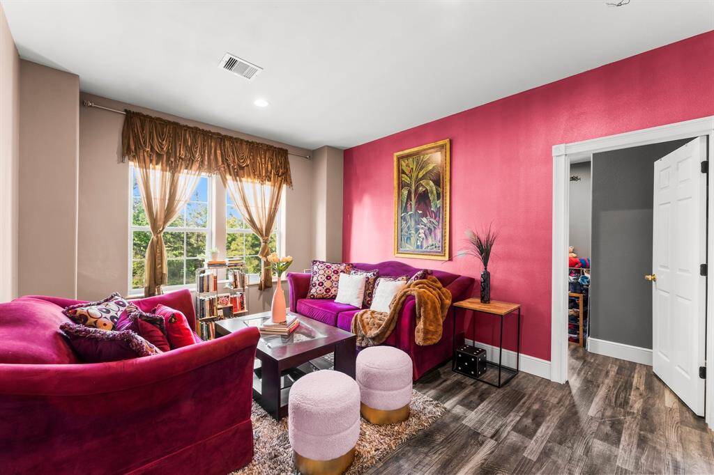 Step into this vibrant living area, showcasing a bold color palette and a comfortable, inviting atmosphere. This stylish space is perfect for relaxing and expressing your unique personality.