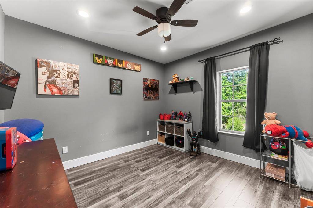 This flexible bedroom offers great natural light and can easily adapt to various needs, whether it's a child's room, guest room, or home office. The stylish flooring and neutral walls provide a versatile backdrop.