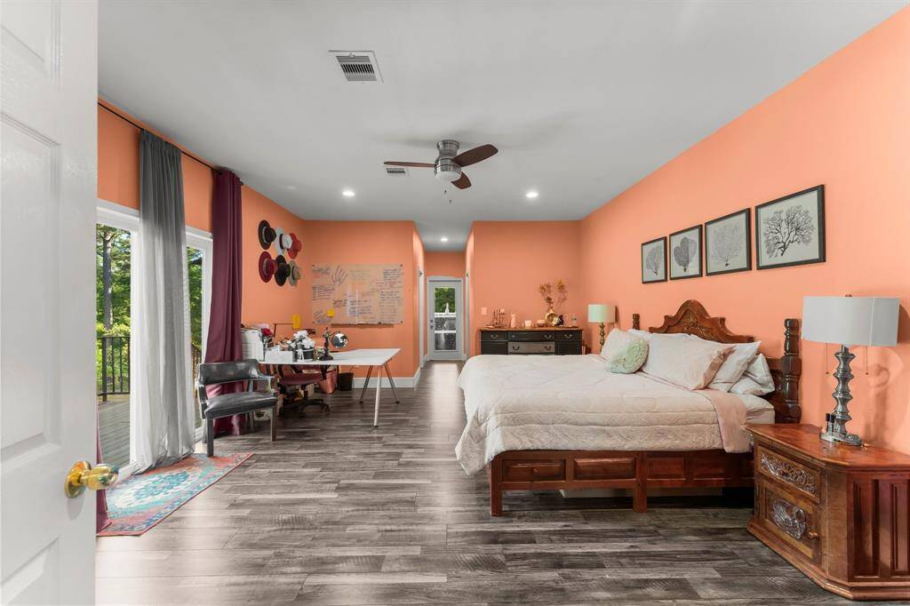 Imagine the possibilities in this substantial bedroom, offering the space to create a true master suite with a separate relaxation or work zone. Enjoy the comfort of a ceiling fan and the natural light streaming in.