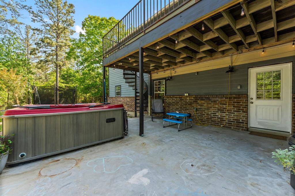 Discover the possibilities for outdoor fun and relaxation in this backyard space. Featuring a hot tub and ample patio area, it's ready for your personal touches and outdoor gatherings.