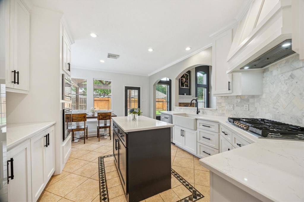 The kitchen has custom built cabinets that go all the way to the ceiling and feature soft close drawers and cabinets!