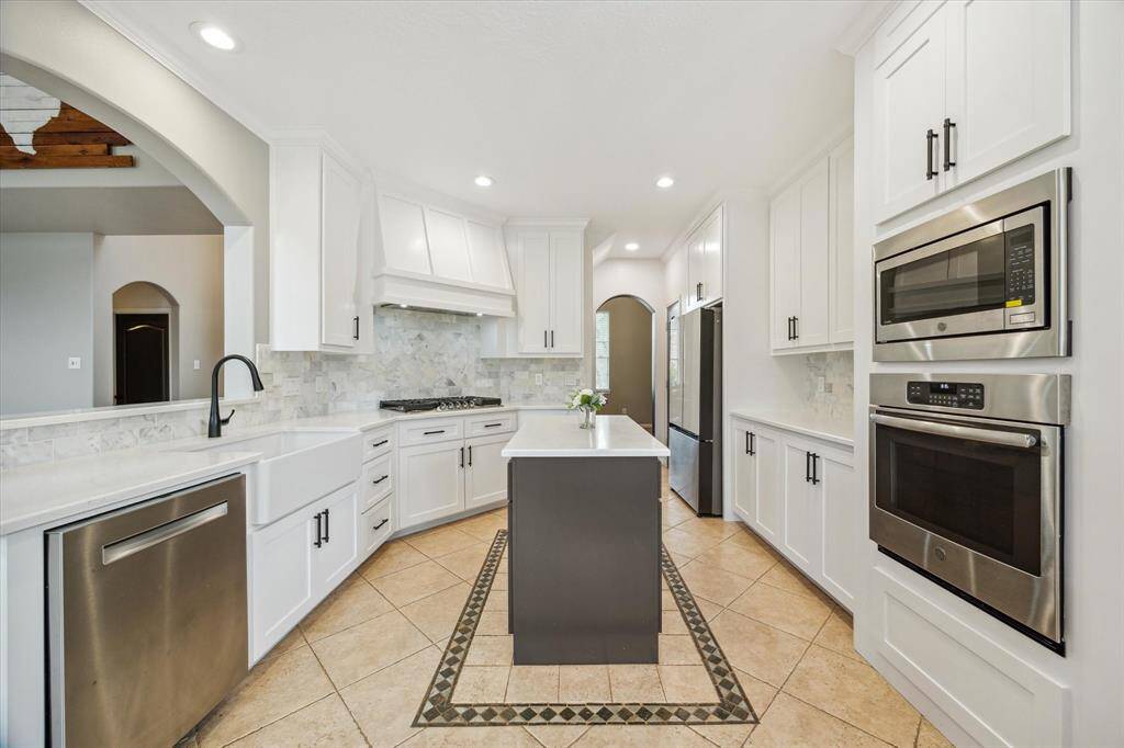 Stainless high end appliances and thick  quartz countertops finish this custom kitchen off!