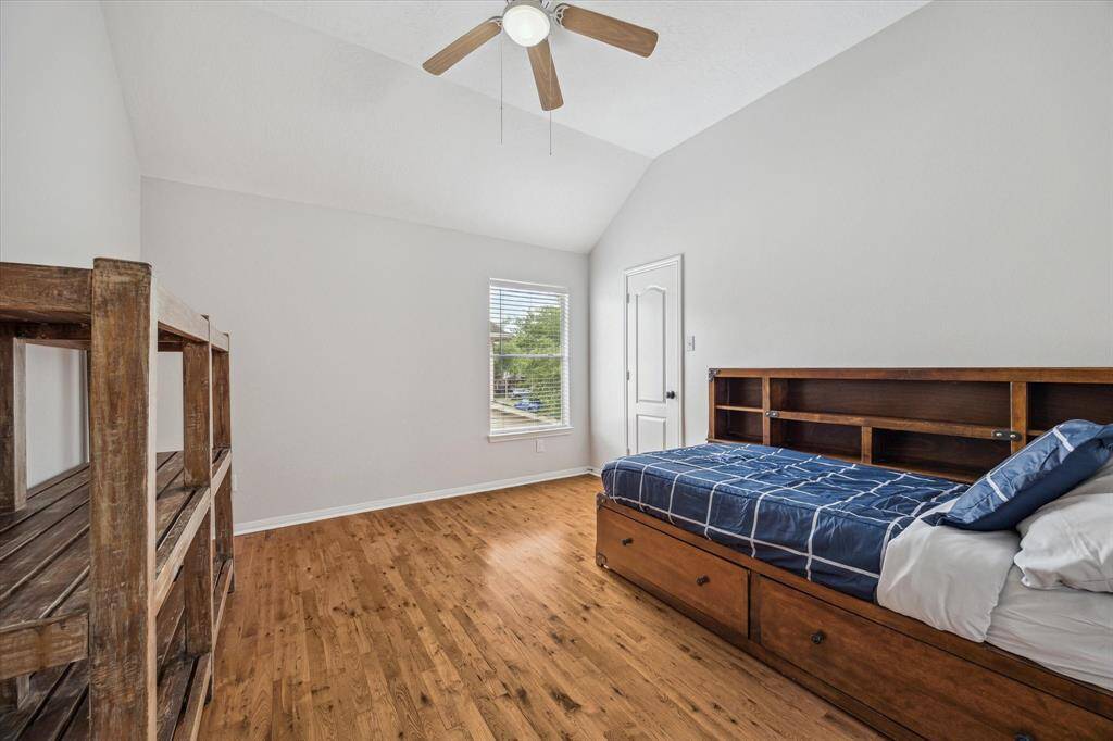 Secondary bedroom with real hardwood floors and a walk in closet! This bed and mattress can stay!
