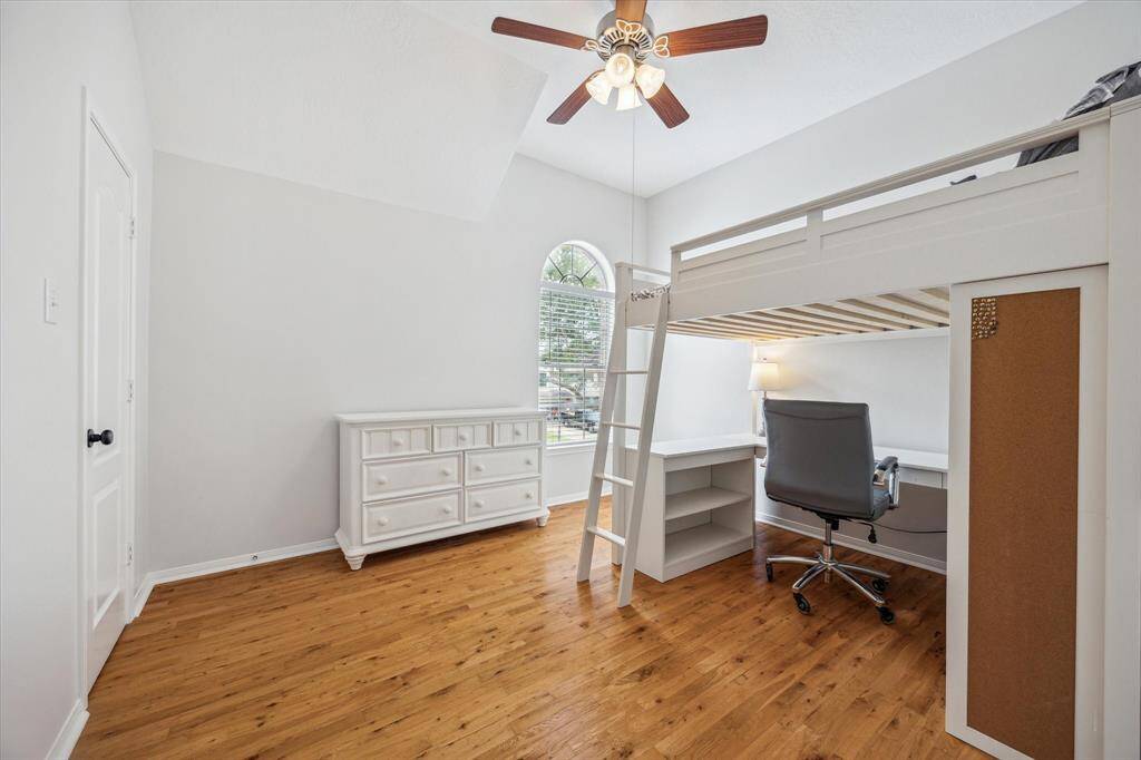Secondary bedroom with real hardwood floors and walk in closet.  This bed can stay!