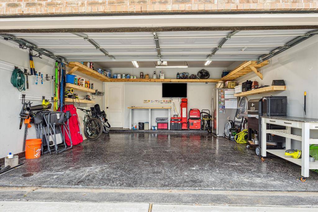 2 car garage with commercial grade epoxy flooring and built in shelving!