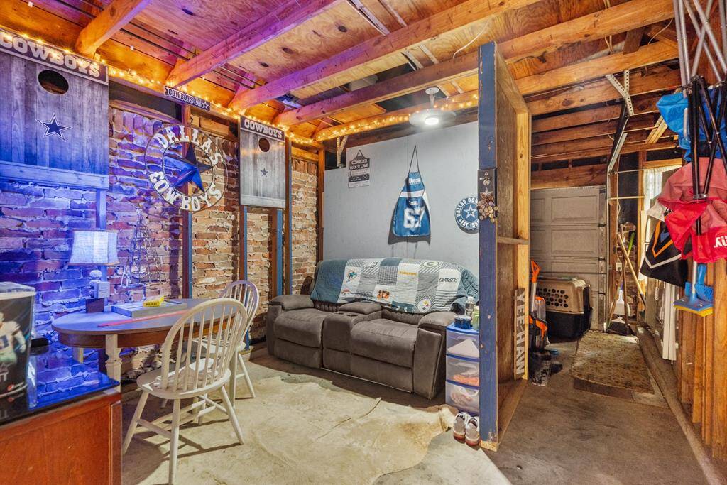 A well-designed man cave tucked into the front part of the garage, offering a cozy, laid-back space for relaxation and entertainment. With comfortable seating, stylish decor, and a personal touch, this retreat combines the best of comfort and functionality, seamlessly blending with the garage's practical layout.