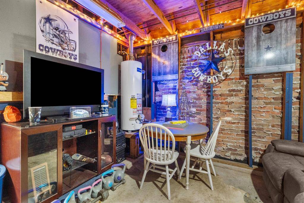 A cozy man cave located in the front section of the garage, featuring comfortable furnishings and a laid-back, personalized atmosphere. This space is perfect for unwinding, with its unique blend of garage practicality and homey comfort, making it an ideal spot for both relaxation and entertainment.