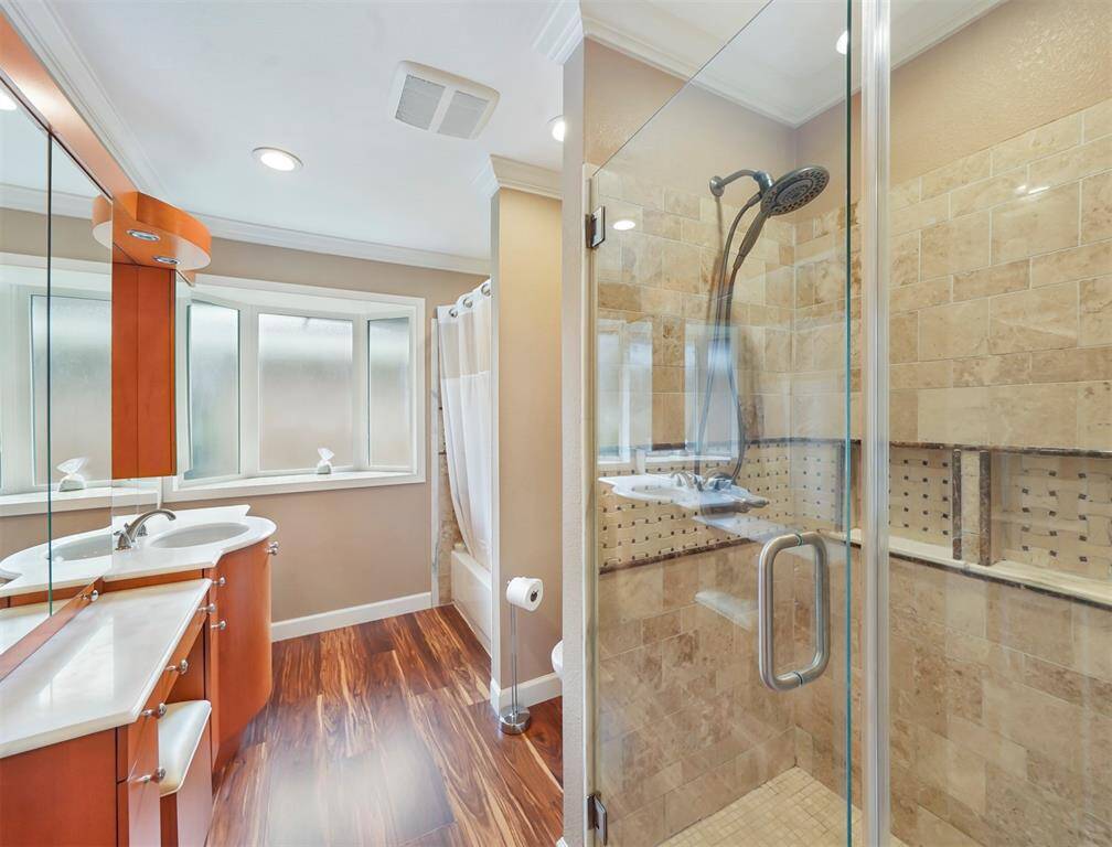 Step into the luxurious spa-like bath, with custom tile shower, vanity, soaking tub and all that natural light.