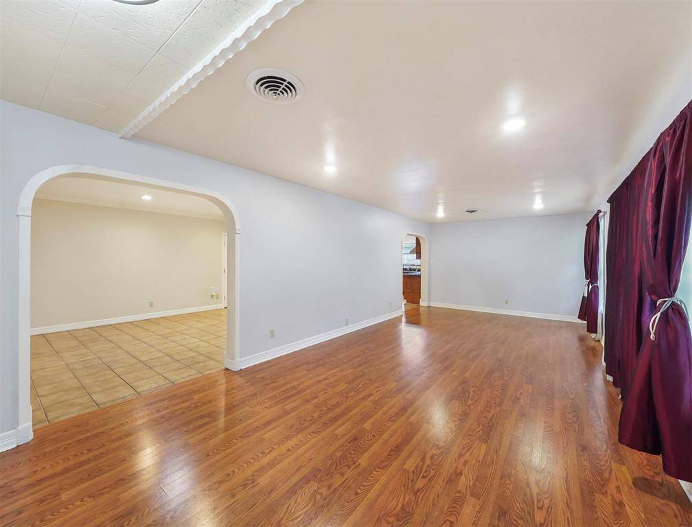 Step directly into the main living space, notice the premium hardwood flooring.