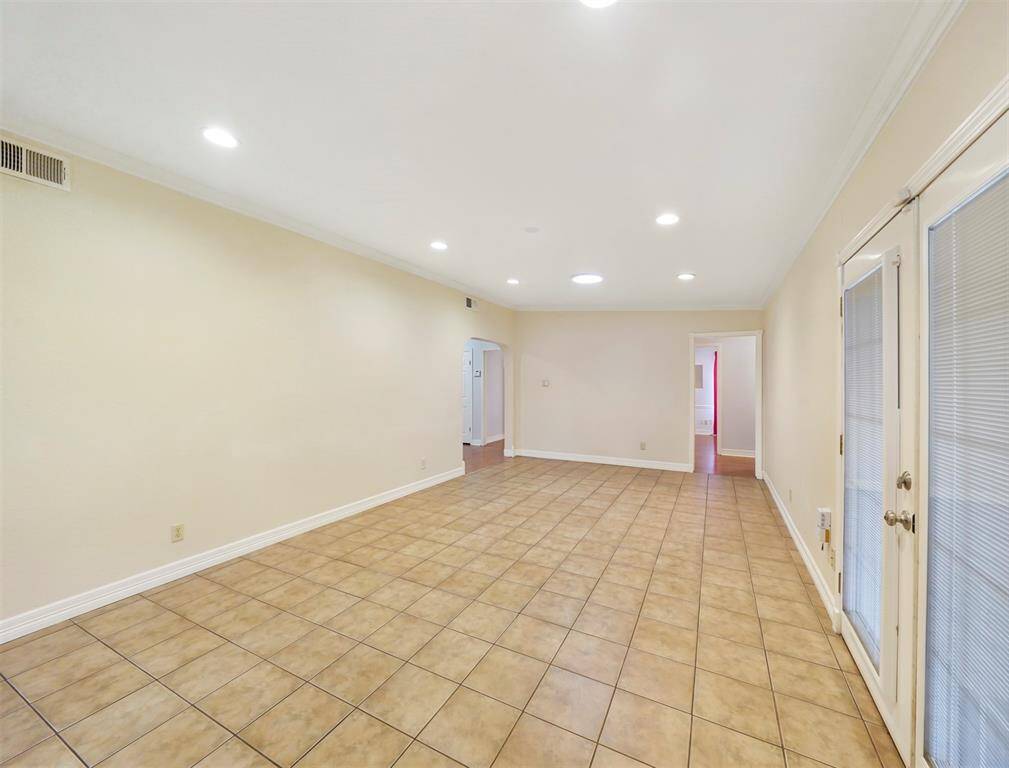 A view of the dining space from the kitchen looking back toward the living room and hall to the bedrooms and bath.