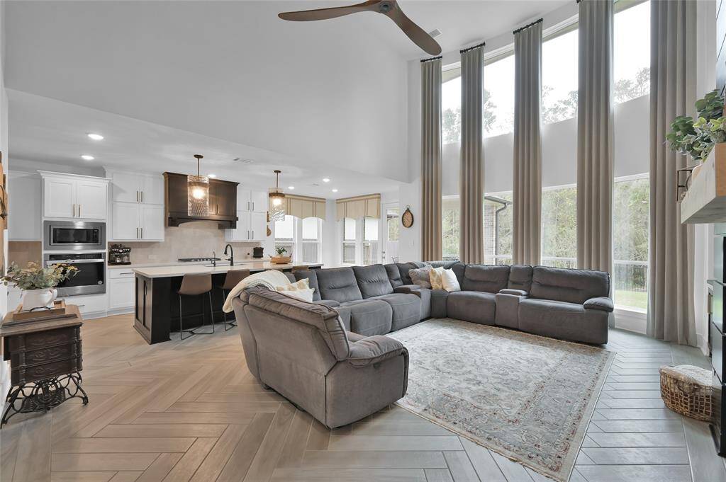 This home boasts natural light throughout with floor to ceiling two-story windows!