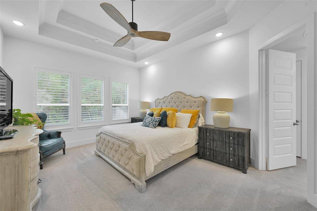 Over-sized primary bedroom features a wall of windows!