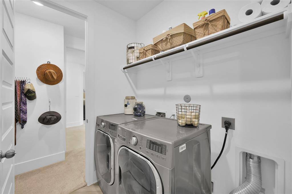 Utility room is conveniently located off the front hallway downstairs and offers access from the primary bedroom closet!