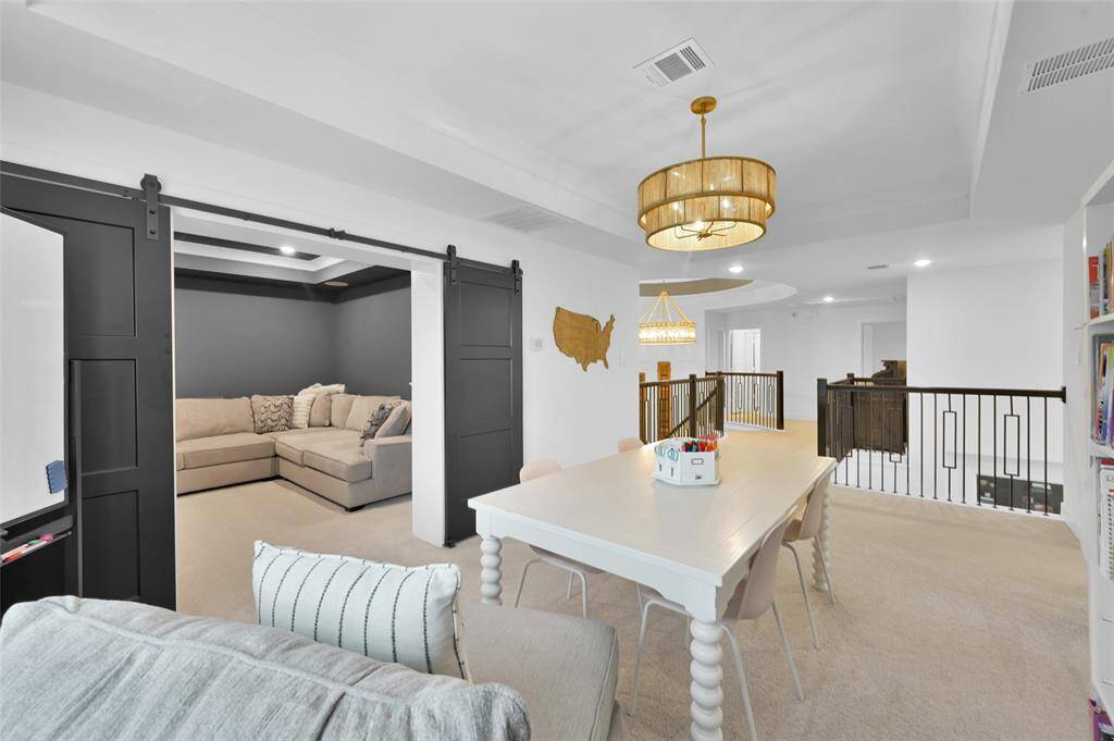 The media room, with upgrades throughout, is located just off the upstairs game/flex room.