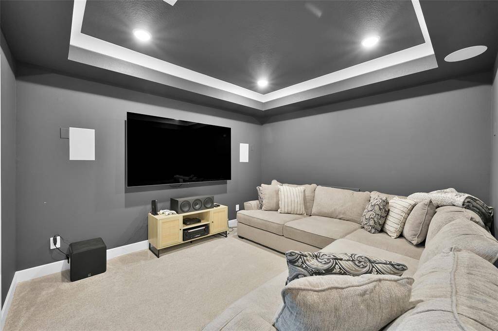 Media room upgrades include barn doors, upgraded paint, built-in surround sound speakers, added recessed lighting, AND a BUILTIN SNACK BAR w/ beverage fridge.