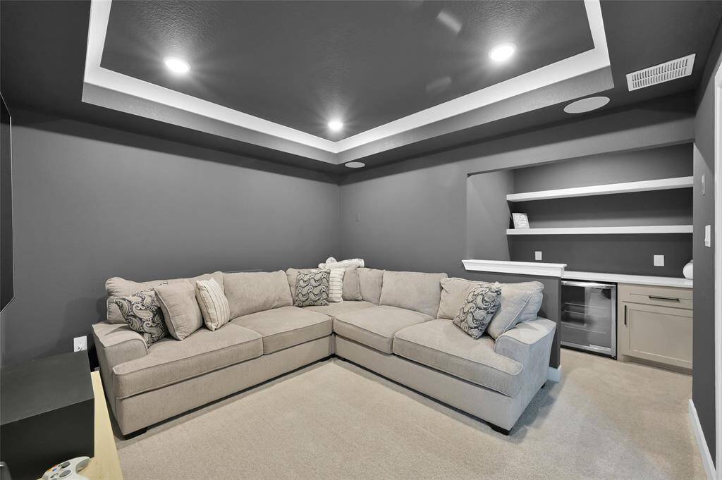 Media room upgrades include barn doors, upgraded paint, built-in surround sound speakers, added recessed lighting, AND a BUILTIN SNACK BAR w/ beverage fridge.