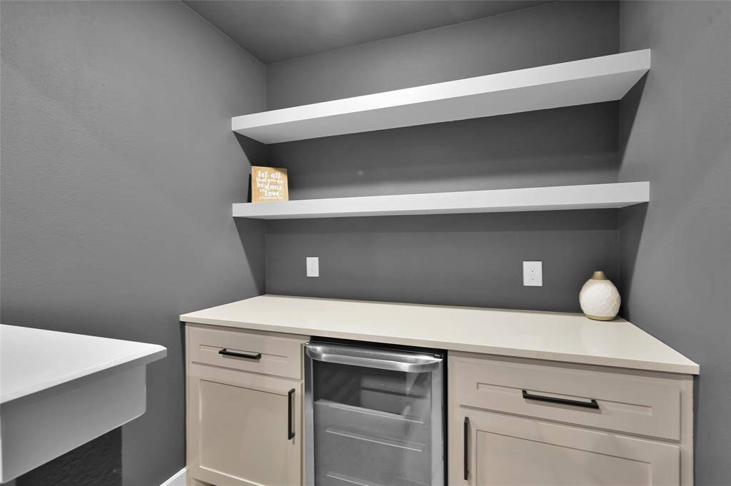 Media room upgrades include barn doors, upgraded paint, built-in surround sound speakers, added recessed lighting, AND a BUILTIN SNACK BAR w/ beverage fridge.