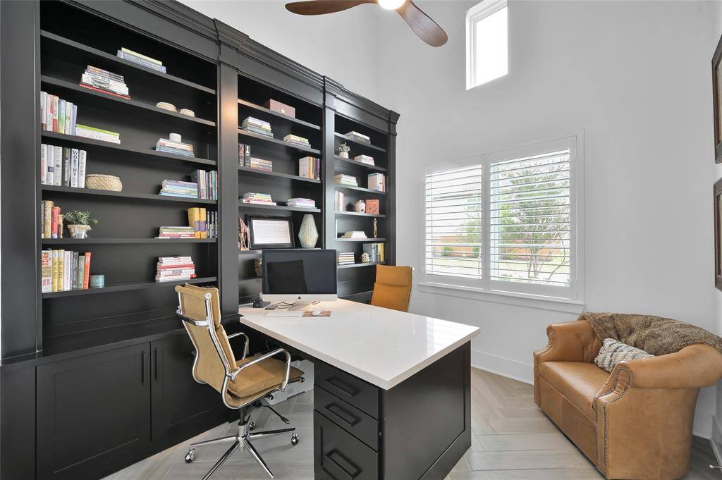 This study/office features custom builtins, double sided desk, upgraded fan, plantation shutters, and French doors.