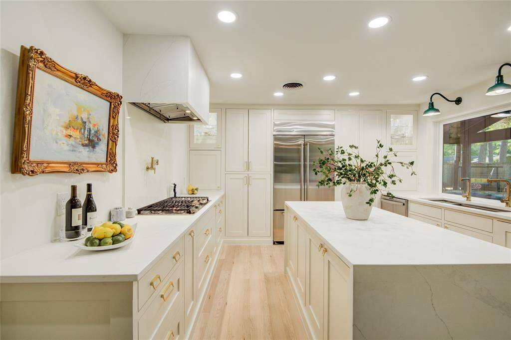 Tons of storage including lighted crystal and china displays, double floor to ceiling pantry, dual pull-out spice racks and extra-deep drawers and cabinets.