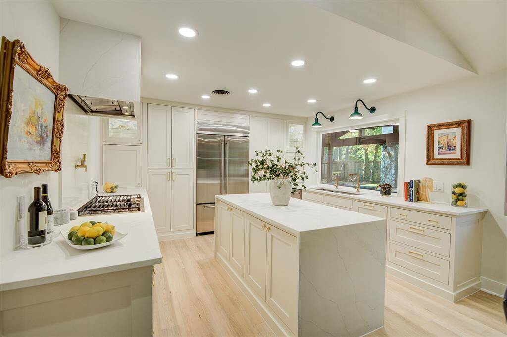 The crown jewel of this home is the kitchen! Can you see the room that's hiding to the right of the fridge?