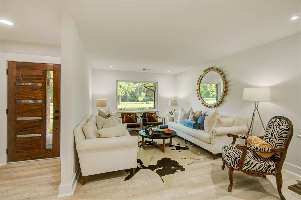 Through the foyer, enjoy conversations in the formal living while taking in views through the large picture window.