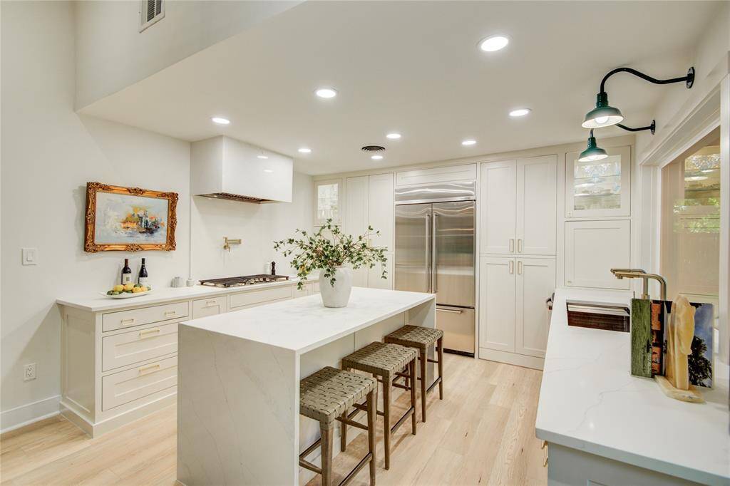 Professionally designed kitchen featuring custom solid birch inset cabinets; large island with tons of storage & waterfall edges.