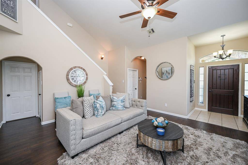 Warm wood and sleek tile flooring carry throughout the primary living spaces, creating a seamless, unified look that blends style with durability.