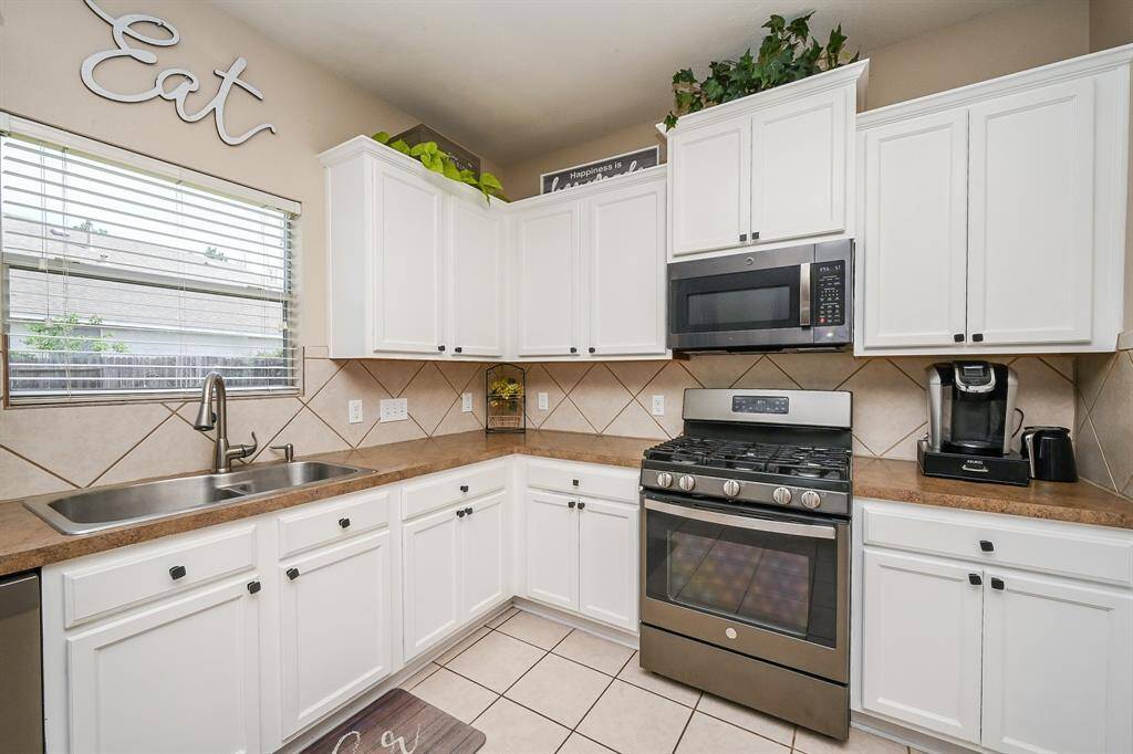 With an abundance of cabinetry, this kitchen offers exceptional storage solutions—keeping everything organized, accessible, and out of sight for a clean, clutter-free look.