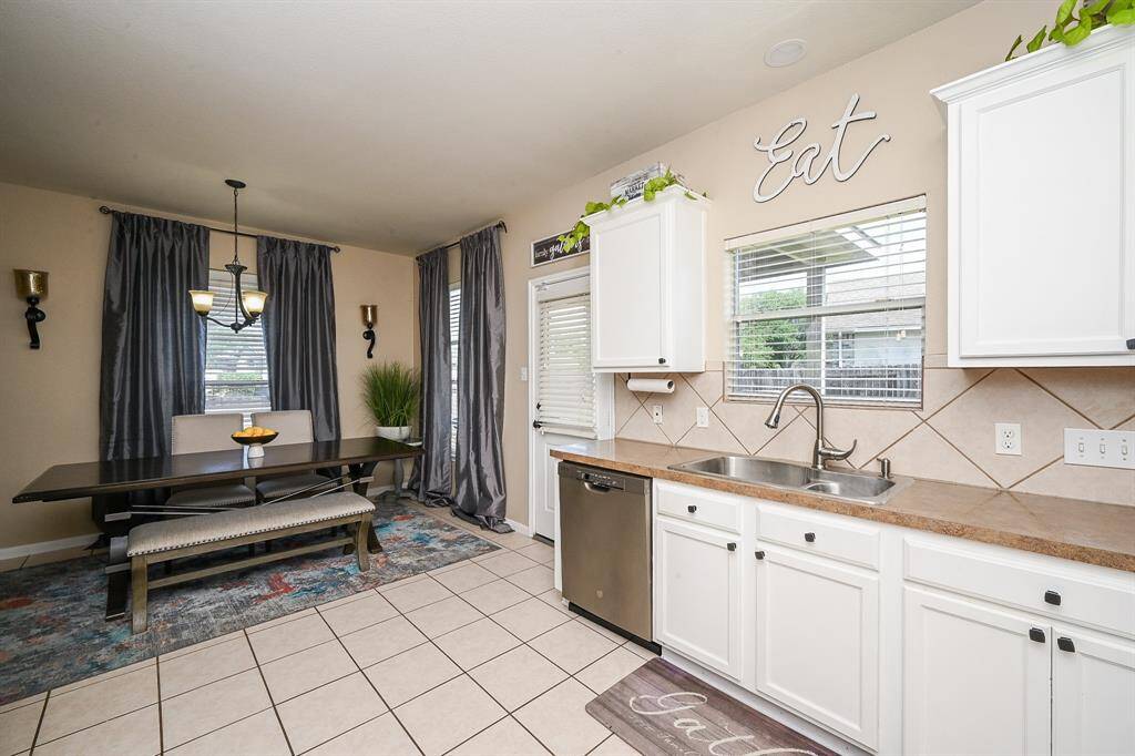 The kitchen flows seamlessly into the breakfast nook, creating a natural transition between the two spaces.