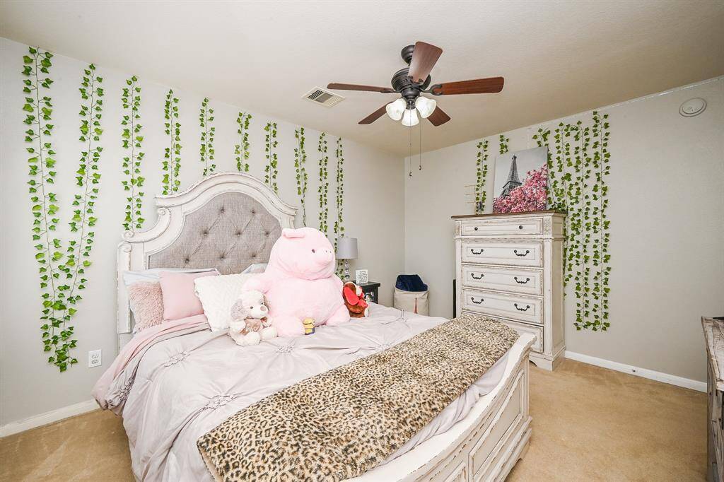 Another secondary bedroom upstairs is designed for comfort and versatility with ample space for furniture. It offers a cozy atmosphere, ideal for a child's room, guest bedroom, or even a quiet study space.