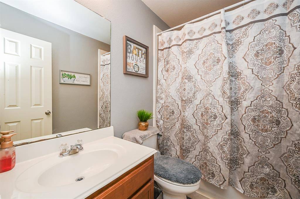 This full bathroom upstairs features a convenient shower/tub combo, offering the best of both worlds for quick showers or a relaxing soak.