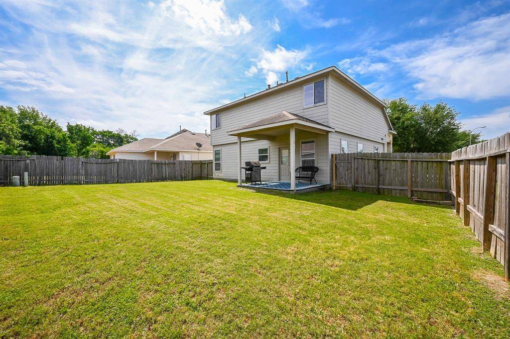 Picture summer barbecues on your covered patio with views of a spacious backyard, perfect for outdoor gatherings.