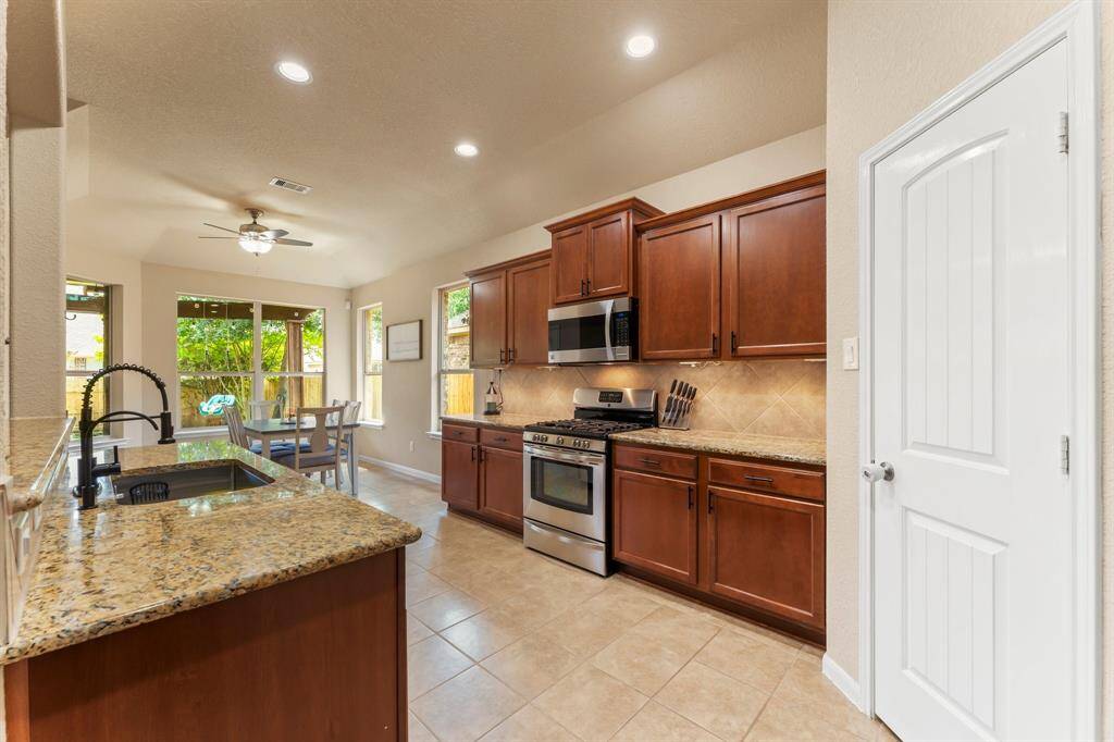 Spacious kitchen with under-cabinet lighting.  Walk-in pantry on the right.
