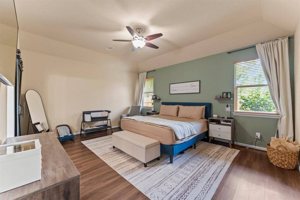 Large primary bedroom with great natural light.  Floors have been updated.