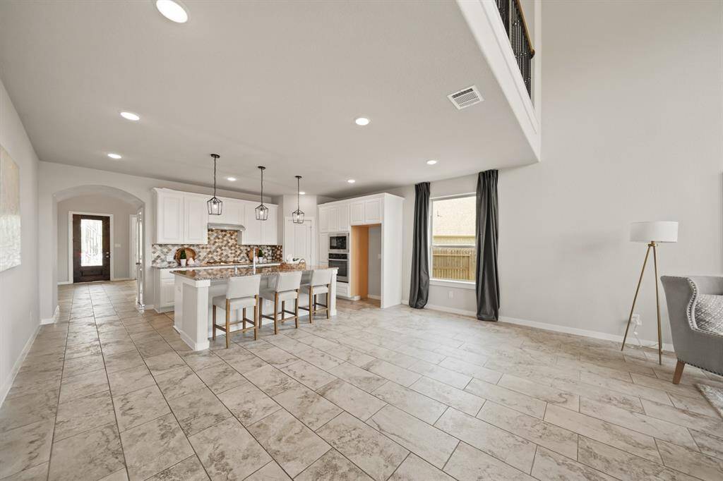 Endless Possibilities, Unmatched Space.This oversized living area flows seamlessly from the open-concept kitchen, featuring a spacious island and abundant room for gatherings. With vast open floors and a thoughtful layout, it’s a bonus space that adapts to your lifestyle, creating an atmosphere of effortless living.