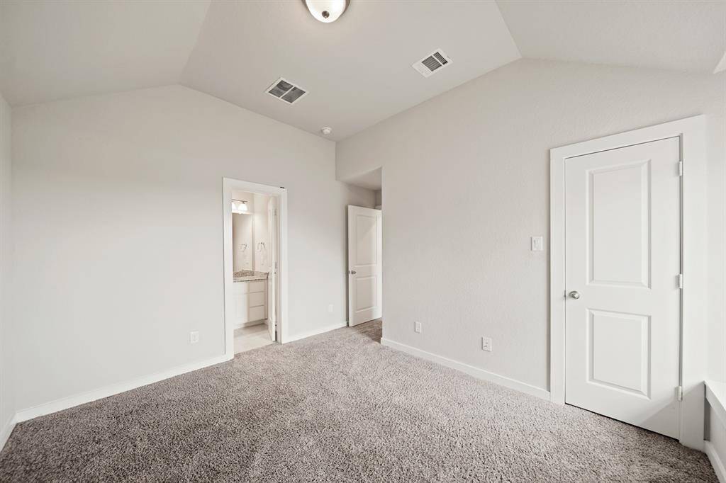 A Cozy En-Suite Escape.From this angle, enjoy the peaceful reading nook by the window, perfect for quiet moments. This en-suite continues to offer privacy, comfort, and a connection to the beautiful outdoors with natural light flowing in.