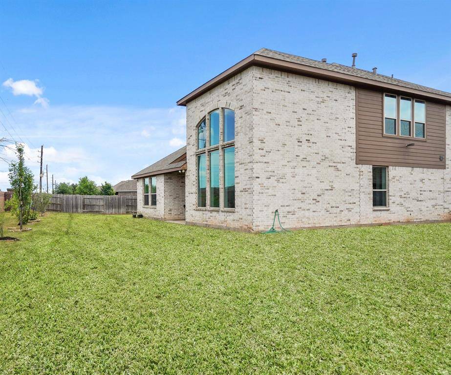Final Angle of the Expansive Backyard.This view captures the full scope of the large backyard, offering a clear look at the other side of the home. With plenty of space to personalize, this yard provides endless possibilities for outdoor enjoyment.