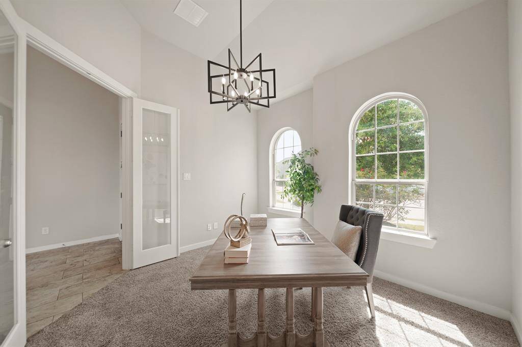 A Sophisticated Retreat.This spacious study, framed by French doors and beautiful windows, fills with natural light, creating the perfect setting for work or relaxation. With ample space for two or more, it’s a room designed for productivity and quiet elegance.