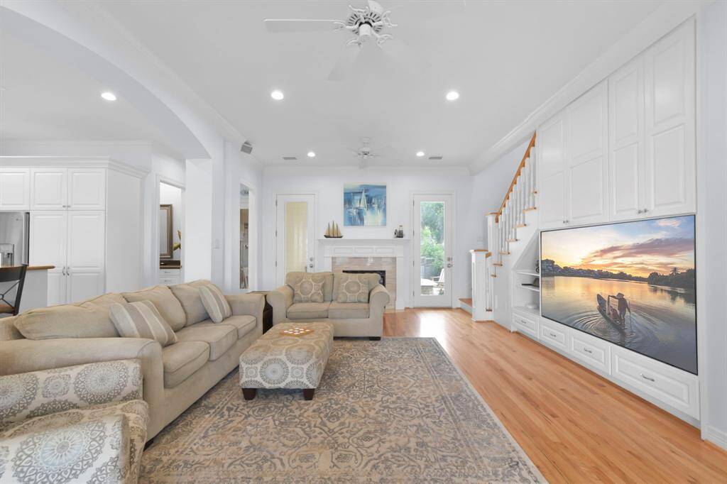 The large den has a gas fireplace and large inset television.