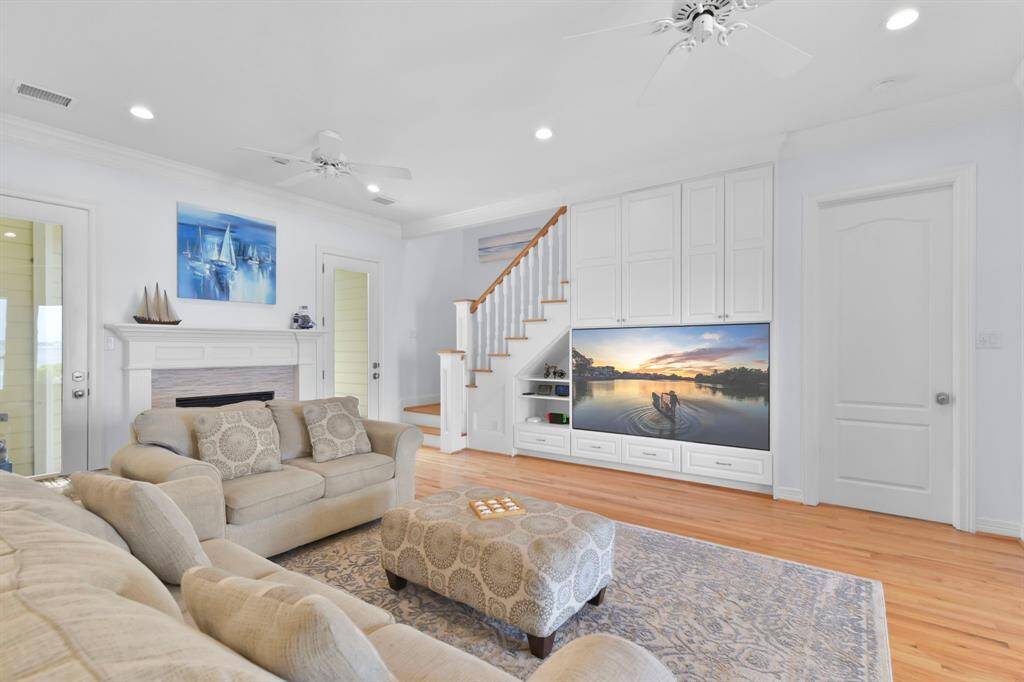 There are two doors that lead to the backyard which has an outdoor fireplace as well as a traquil water feature.
