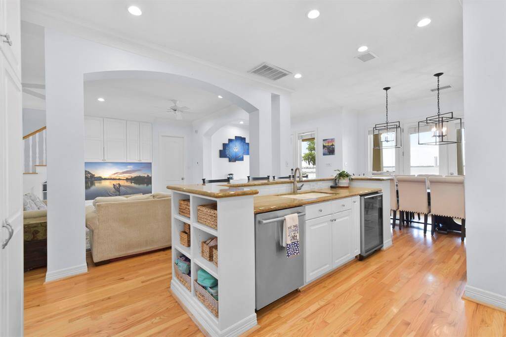 The sink, dish washer, and Beverage cooler are located on the island.