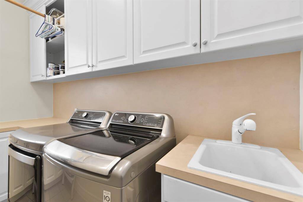 The laundry room is located on the first floor and has an additional sink, and storage.