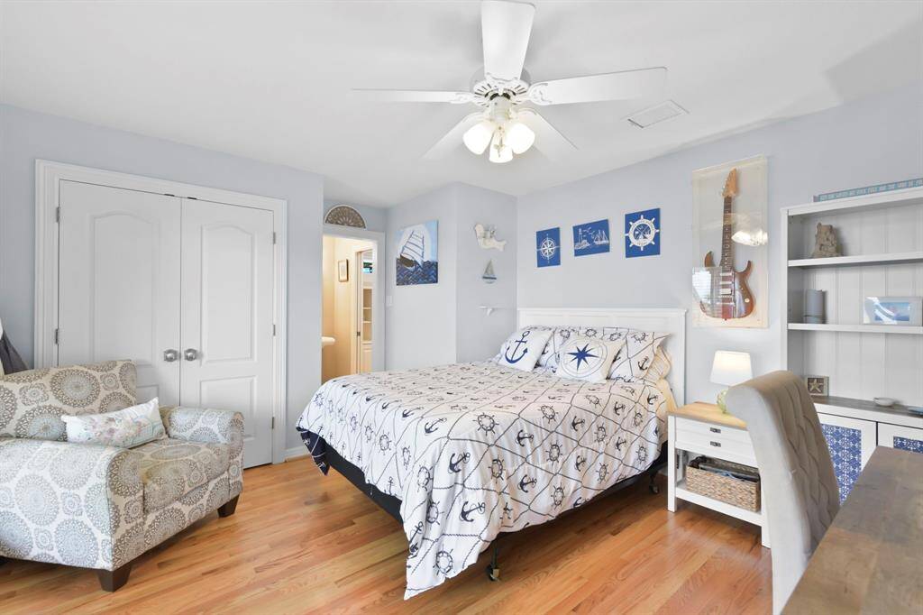The Second Bedroom has an entrance to the Upper Porch, and  view of the Lakefront.