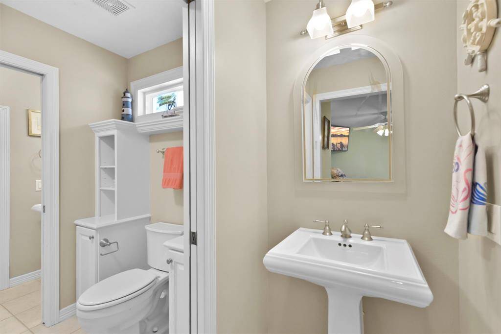 The Jack-N-Jill bathroom has pedastal sinks and a linen closet.