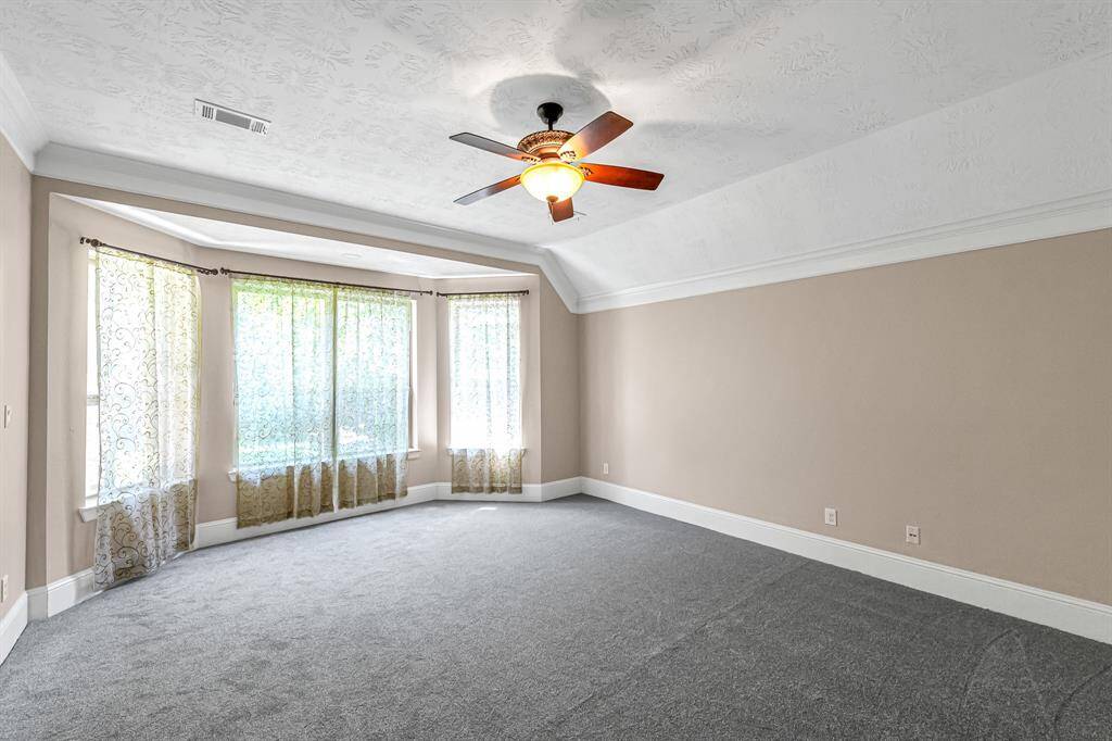 First of the two primary bedrooms features pretty bay window and new carpet!