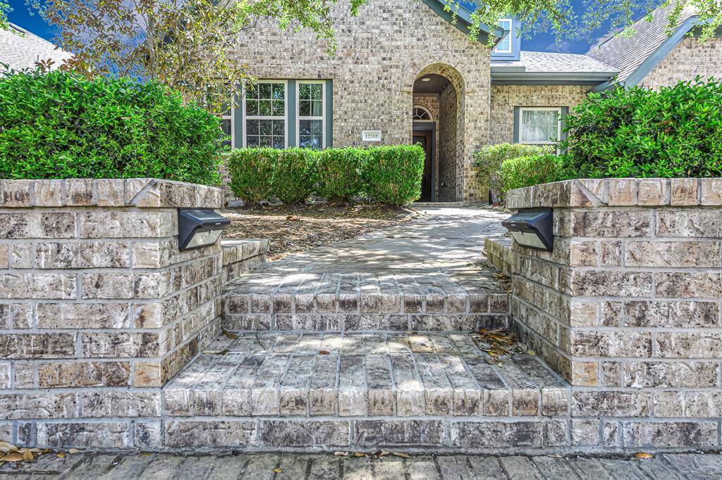 The classic Bridgeland feature of brick retaining wall and steps to the gracious pathway.