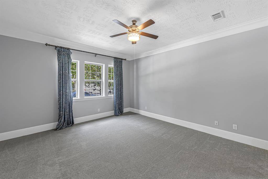 Second bedroom suite functions nicely as a guest suite or second master. Views to the front yard from the bright and cheery window. Notice the crown molding and NEW carpet!